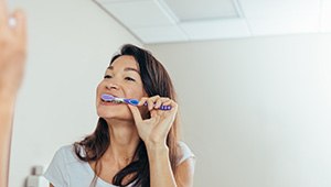 a woman brushing her teeth